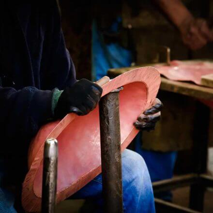 copper bath sink being shaped by a person
