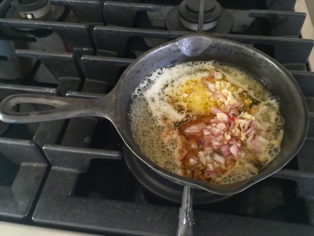 Cast Iron full of butter, garlic and red onions