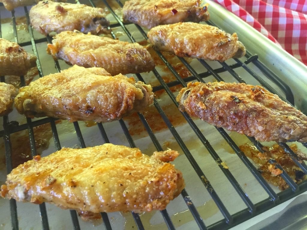 chicken wings resting on baking rack