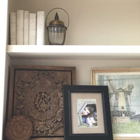desk shelves full of decor and photos