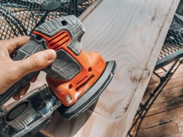 a sander being used on a piece of wood