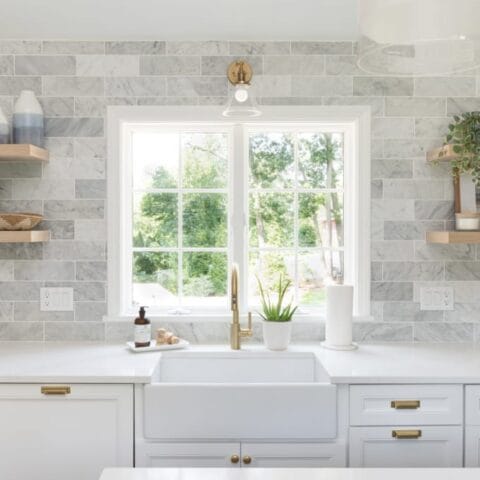 An all white kitchen with matching white fireclay farmhouse sink.