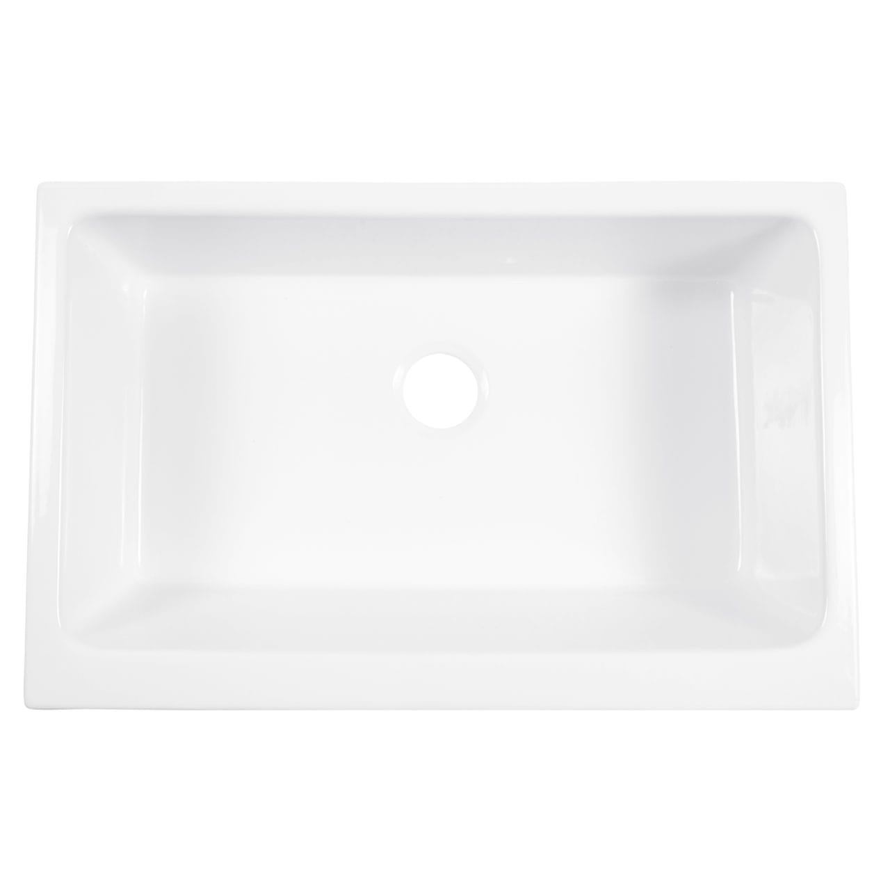 A white fireclay farmhouse kitchen sink.