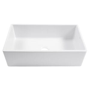 A white fireclay farmhouse kitchen sink.