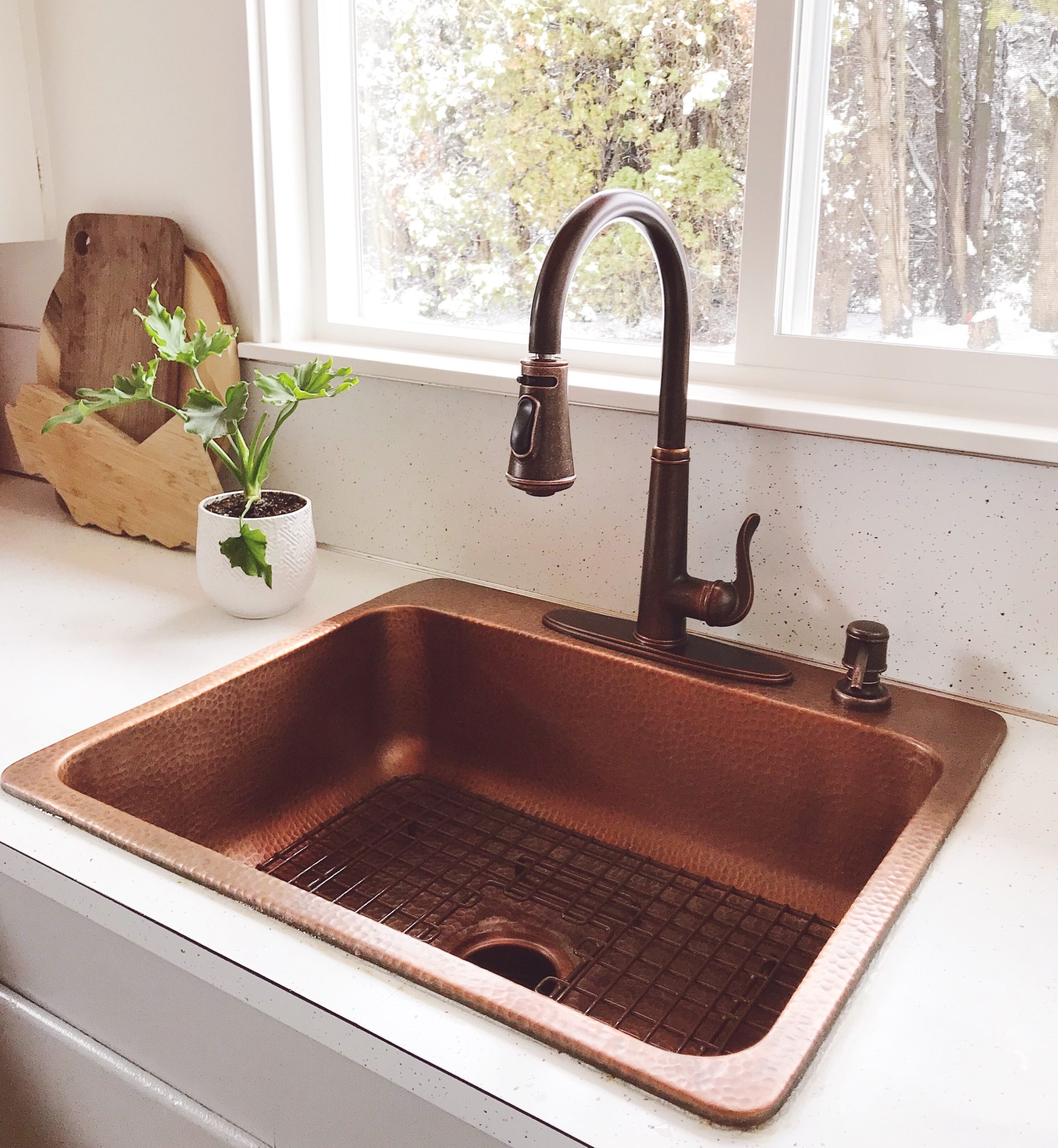 A copper rectangular drop-in sink in a cabin kitchen.