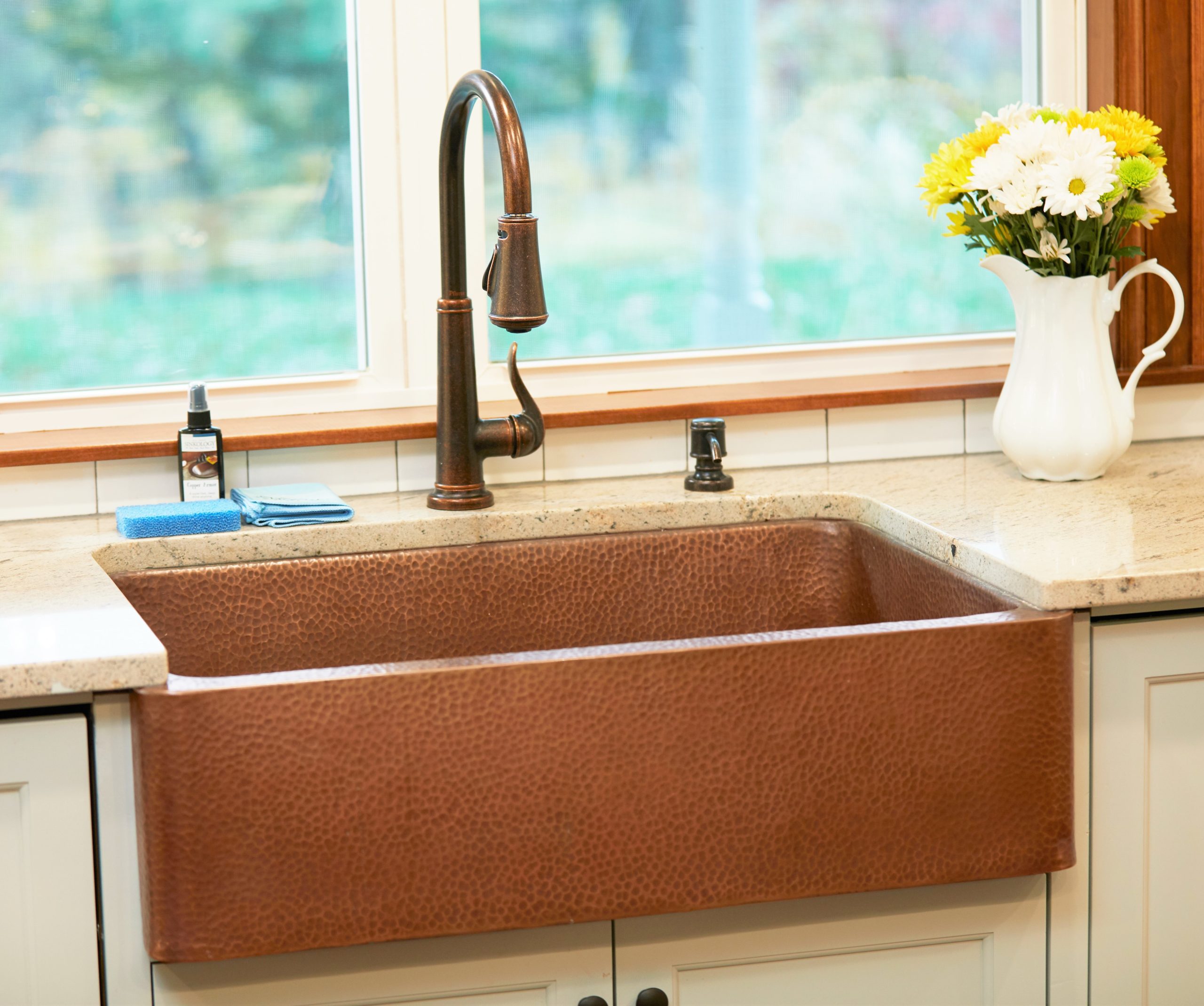 A copper rectangular undermount farmhouse sink in modern farmhouse kitchen.