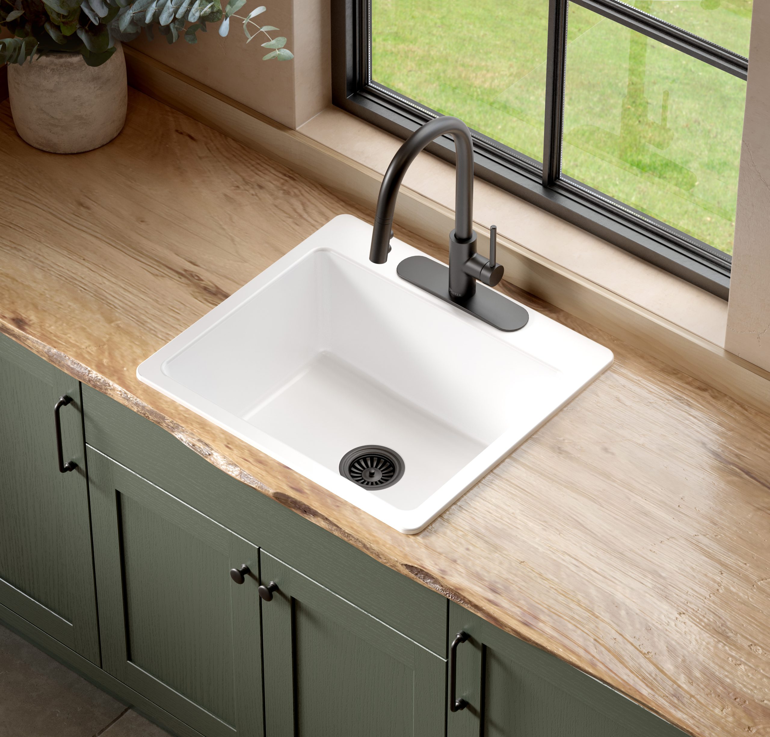 A glossy white rectangular drop-in sink made in fireclay set in wood countertop and green cabinets in front of a window.