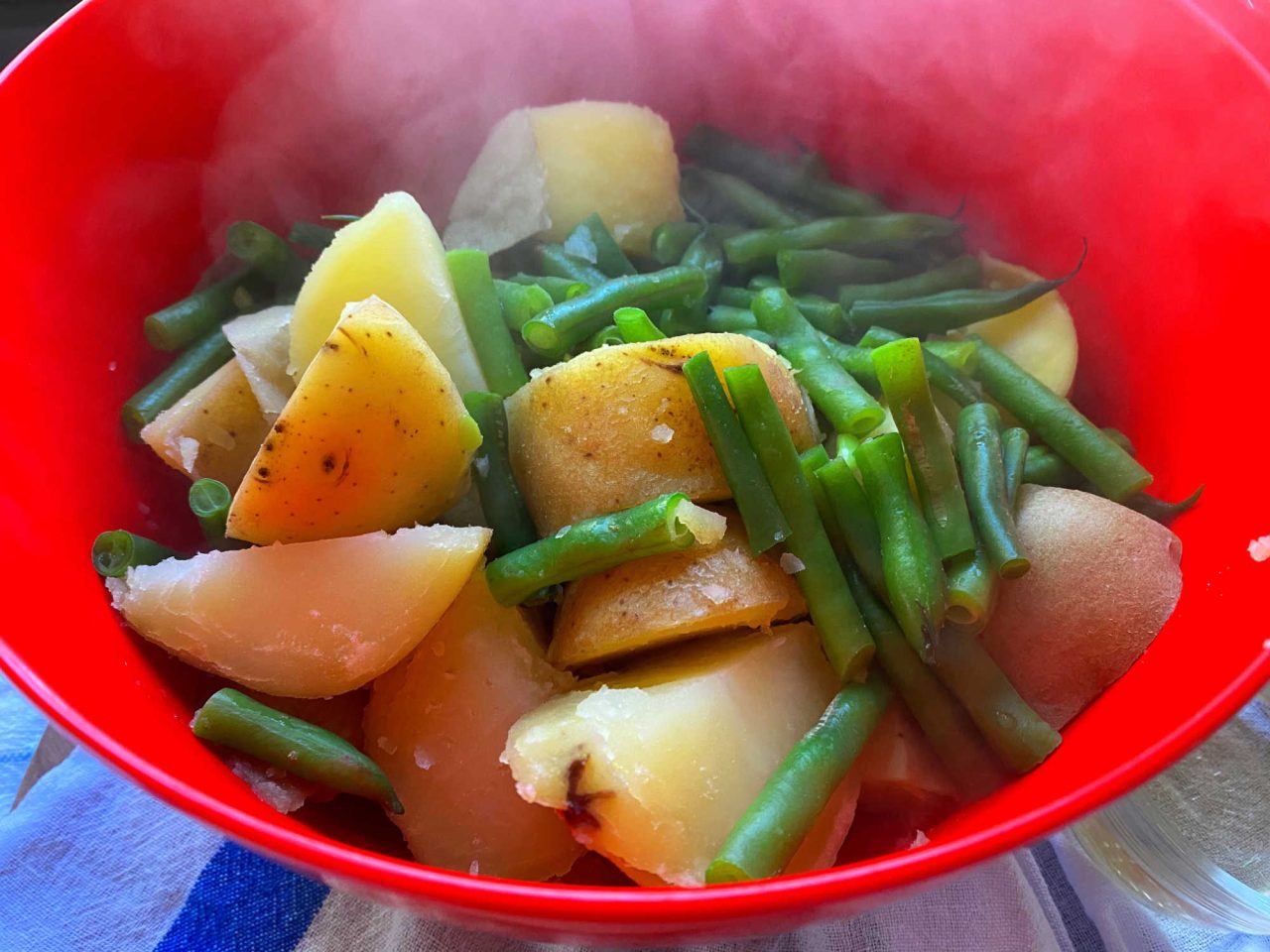 steaming hot potatoes and green beans in a bowl