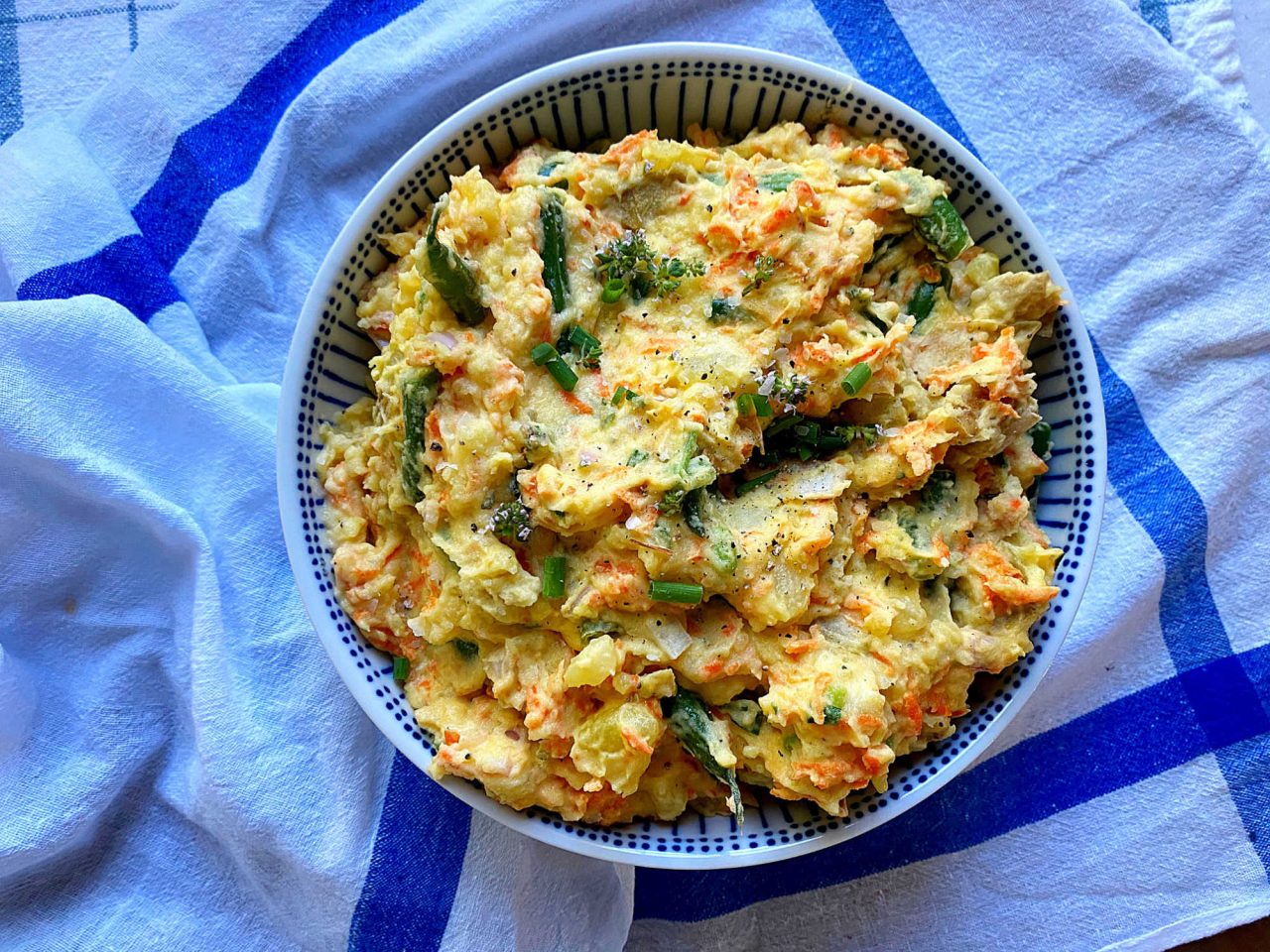 Warm veggies potato salad ingredients in a bowl