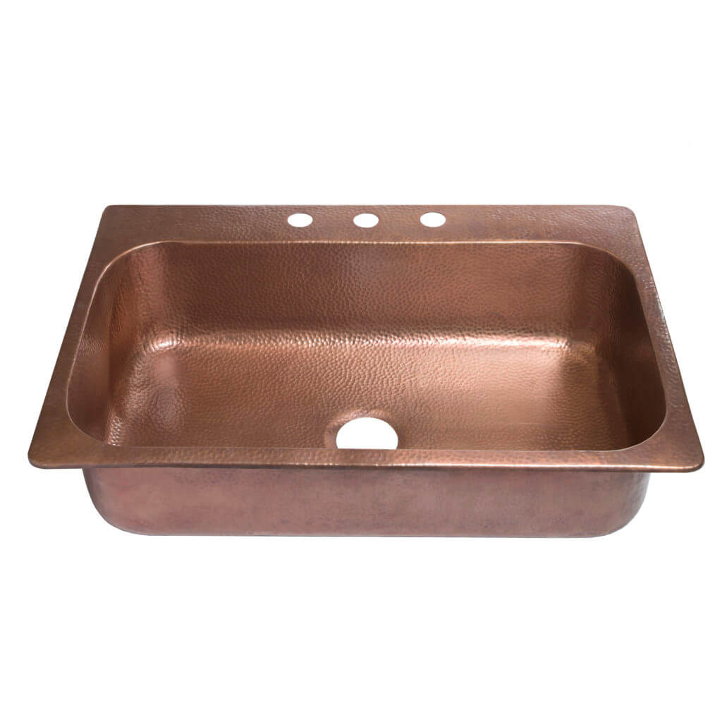 A hammered copper kitchen sink with three faucet holes and a rich, warm finish.