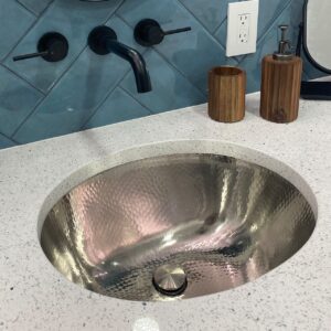 A hand hammered nickel undermount bathroom sink.
