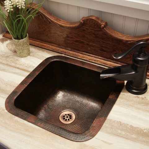 A square hand hammered undermount copper bar and prep sink with a 1.5" drain hole.