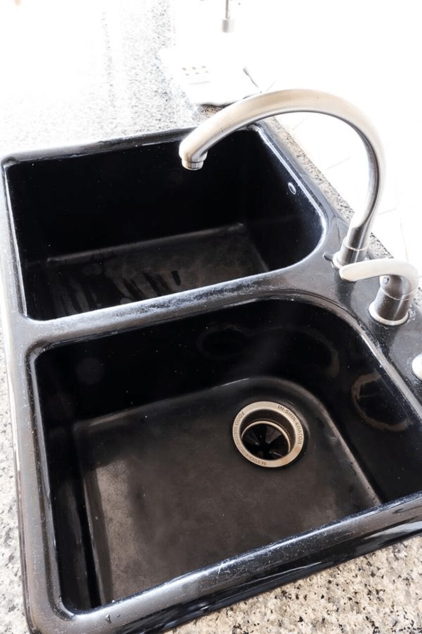a before image of the old black dirty kitchen sink