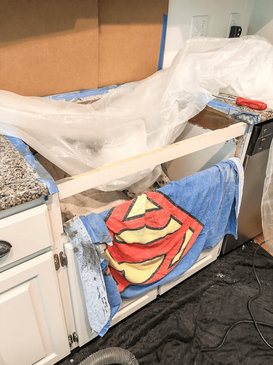 towel on cabinet base to protect agains cutting countertop