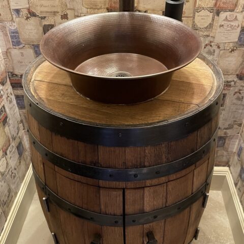 A hand hammered copper vessel bathroom sink.