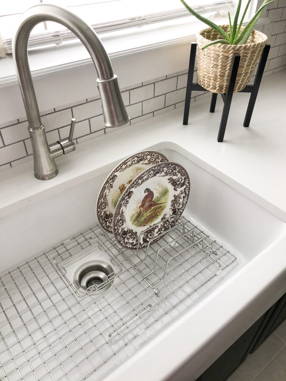 GridLogic Stainless Steel Organizer attached to a bottom grid in a kitchen sink