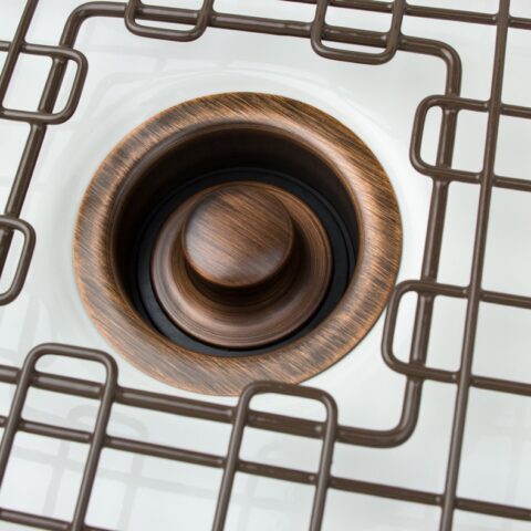 An antique brown kitchen sink disposal drain.