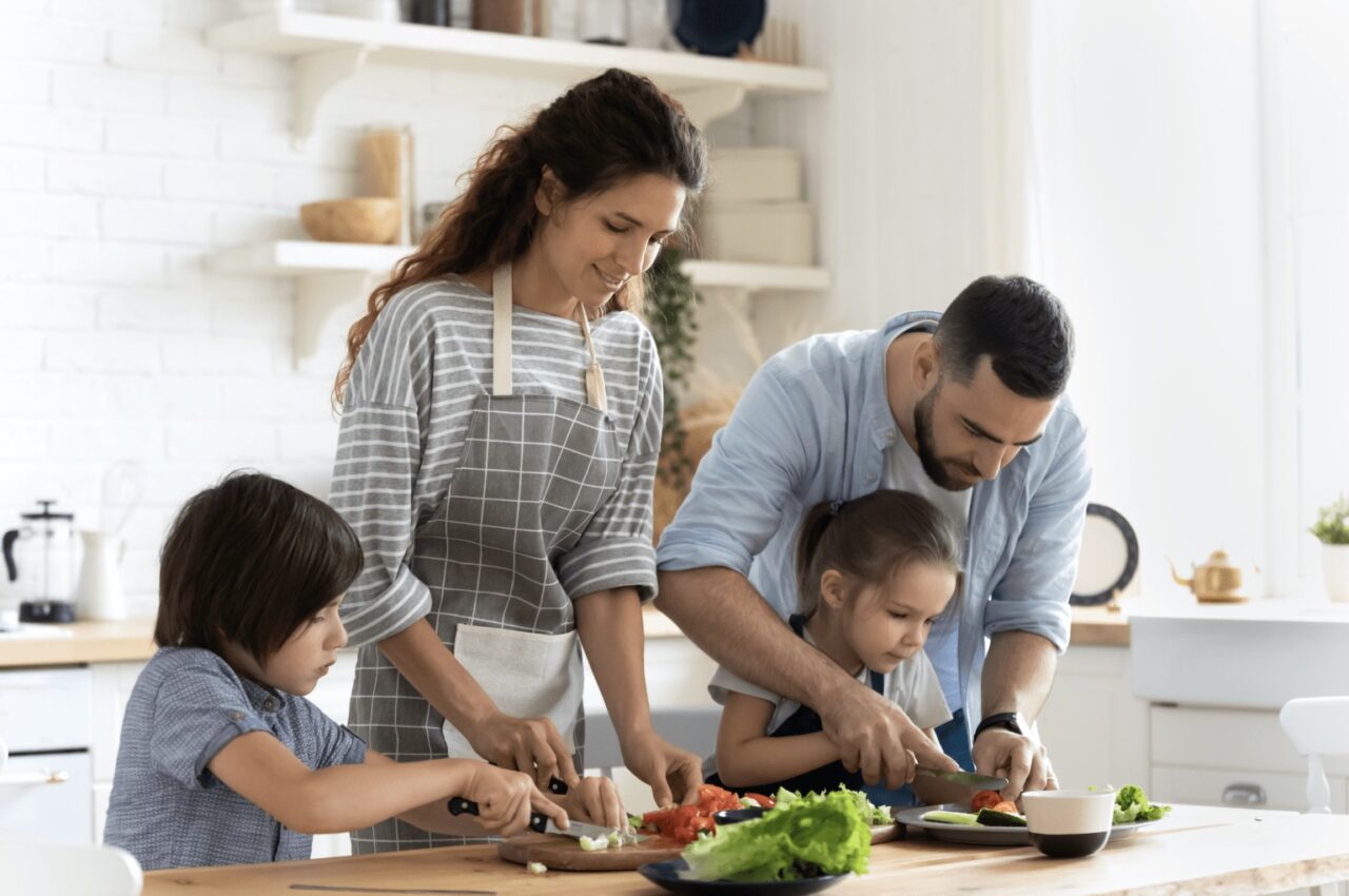 a family prepping food in the kitchen.