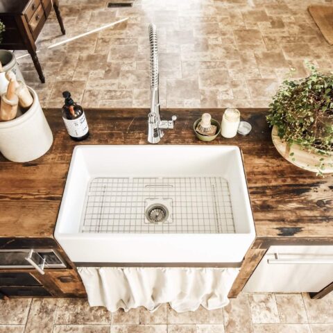 a farmhouse sink with a bottom grid