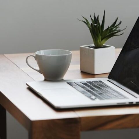 a computer on a dining table.