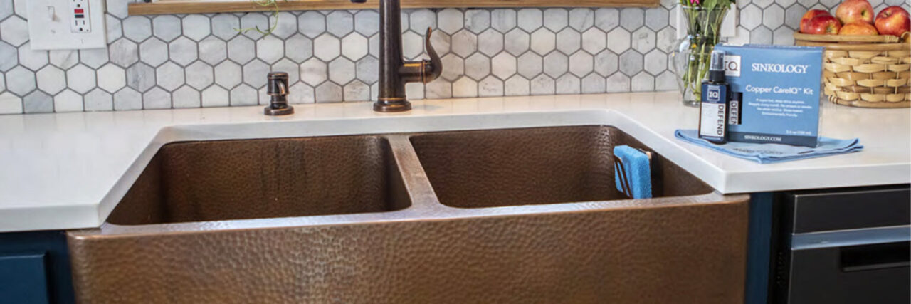 A detailed close up image of a copper kitchen sink.